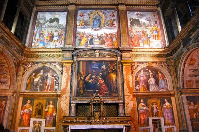 Frescoed walls and altar of the church of San Maurizio al Monastero Maggiore, covered floor to ceiling in Renaissance paintings